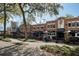 Charming mixed-use building featuring outdoor seating with shaded tables, a brick facade, and appealing architecture at 636 Bainbridge Loop, Winter Garden, FL 34787