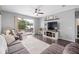 Comfortable living room featuring a ceiling fan and sliding glass doors to the outdoor patio at 636 Bainbridge Loop, Winter Garden, FL 34787