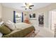 Bright bedroom showcasing a ceiling fan, closet, and a large window offering outdoor views at 636 Bainbridge Loop, Winter Garden, FL 34787