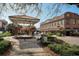 Picturesque downtown street corner view with lush landscaping, a gazebo, and commercial buildings in the background at 636 Bainbridge Loop, Winter Garden, FL 34787