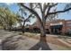 Picturesque commercial street view, featuring brick buildings with awnings, shaded outdoor seating, and mature trees at 636 Bainbridge Loop, Winter Garden, FL 34787