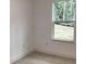 Bright bedroom featuring white walls, wood-look flooring, and natural light from a large window at 6889 Se 23 Ave, Ocala, FL 34480