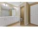 Bathroom features double sinks, tile flooring, a walk-in shower and a separate toilet room at 6912 Hochad Dr, Orlando, FL 32819