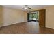 Bright bedroom featuring wood-style tile flooring and sliding doors to the screened patio at 6912 Hochad Dr, Orlando, FL 32819