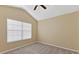 A bedroom featuring neutral carpet, single window, ceiling fan, and vaulted ceiling at 6912 Hochad Dr, Orlando, FL 32819
