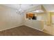 A dining room featuring a chandelier and wood-style tile flooring, adjacent to the kitchen at 6912 Hochad Dr, Orlando, FL 32819