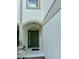 Inviting front entrance with a green door, sidelight window, and arched entryway at 6912 Hochad Dr, Orlando, FL 32819