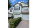 Attractive townhomes with two-car garages, tile roofs, and manicured shrubbery in a shared driveway at 6912 Hochad Dr, Orlando, FL 32819