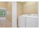 Convenient laundry area with a washer, dryer, and built in wire shelving at 6912 Hochad Dr, Orlando, FL 32819
