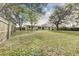 Large backyard with trees and wooden fence at 812 Oleander St, New Smyrna Beach, FL 32168