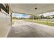 Spacious carport featuring a concrete floor and view of the surrounding neighborhood at 812 Oleander St, New Smyrna Beach, FL 32168