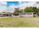 Well-kept single-story home with a spacious front lawn and covered carport at 812 Oleander St, New Smyrna Beach, FL 32168