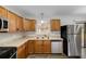 Close-up of kitchen cabinets with modern appliances and a double basin stainless steel sink at 812 Oleander St, New Smyrna Beach, FL 32168