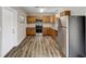 Well-lit kitchen with stainless steel appliances, light wood cabinets, and attractive wood-look flooring at 812 Oleander St, New Smyrna Beach, FL 32168