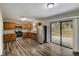 Modern kitchen with stainless steel appliances, wood cabinets, and sliding glass door to backyard at 812 Oleander St, New Smyrna Beach, FL 32168