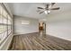 Spacious living room with wood-look floors and a view into the adjacent kitchen at 812 Oleander St, New Smyrna Beach, FL 32168