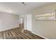 Neutral living room with wood-look flooring and a window providing natural light at 812 Oleander St, New Smyrna Beach, FL 32168