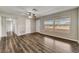 Open-concept living room with beautiful wood floors, neutral paint, and multiple windows at 812 Oleander St, New Smyrna Beach, FL 32168