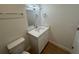 Bright bathroom with a single sink vanity, mirror, and a modern light fixture at 950 20Th St, Orlando, FL 32805