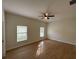 Spacious bedroom featuring two windows, wood floors, and a ceiling fan at 950 20Th St, Orlando, FL 32805