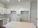 Well-lit kitchen featuring an island, white cabinetry and stainless steel appliances at 950 20Th St, Orlando, FL 32805