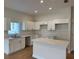 Spacious kitchen with quartz countertop island, white cabinets and stainless steel appliances at 950 20Th St, Orlando, FL 32805