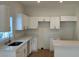 Modern kitchen featuring an island, white cabinetry and stainless steel appliances at 950 20Th St, Orlando, FL 32805