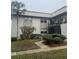 Charming condo featuring well-maintained landscaping with mature palm trees and decorative bushes at 96 Windtree Ln # 203, Winter Garden, FL 34787