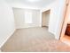 A bright bedroom features neutral walls, carpet, and a walk-in closet, offering ample storage space at 1132 Chelsea Dr, Davenport, FL 33897