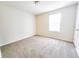 This bright bedroom features neutral walls, carpet, and a window for natural light at 1132 Chelsea Dr, Davenport, FL 33897