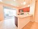 Bright, modern kitchen featuring stainless steel appliances and breakfast bar at 1132 Chelsea Dr, Davenport, FL 33897