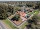 Aerial view of a home featuring a pool, patio, fenced yard, and mature trees at 1031 Kings Hwy, Kissimmee, FL 34744