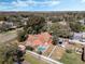 Aerial view of a home featuring a spacious lot with a pool, patio, and lush landscaping at 1031 Kings Hwy, Kissimmee, FL 34744