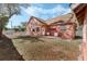 View of the rear of the residence, featuring a brick patio and ample backyard space at 1031 Kings Hwy, Kissimmee, FL 34744