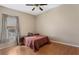 Bedroom features hardwood floors, ceiling fan, and a window with natural light at 1031 Kings Hwy, Kissimmee, FL 34744