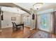 Traditional dining room featuring hardwood floors, elegant lighting, and a decorative rug at 1031 Kings Hwy, Kissimmee, FL 34744