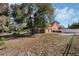 Charming home exterior with a two-car garage, mature trees, and a well-maintained lawn at 1031 Kings Hwy, Kissimmee, FL 34744
