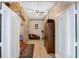Hallway with stone accents, tile flooring, and view to another living space with furniture at 1031 Kings Hwy, Kissimmee, FL 34744