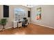 Home office features hardwood floors, ceiling fan, and a window with shutters at 1031 Kings Hwy, Kissimmee, FL 34744