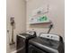 Laundry Room with gray washer and dryer set and a modern vacuum cleaner at 1031 Kings Hwy, Kissimmee, FL 34744