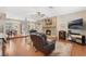 Inviting living room with a fireplace, hardwood floors, and easy access to the dining area at 1031 Kings Hwy, Kissimmee, FL 34744