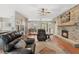 Inviting living room featuring a stone fireplace, hardwood floors, and comfortable leather furniture at 1031 Kings Hwy, Kissimmee, FL 34744