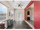 Open-concept living room with slate floors, bright window, and transitional access to the next room at 1031 Kings Hwy, Kissimmee, FL 34744