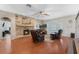 Cozy living room with a stone fireplace, hardwood floors, and a television at 1031 Kings Hwy, Kissimmee, FL 34744