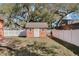 Backyard shed with white trim and fenced yard at 1031 Kings Hwy, Kissimmee, FL 34744