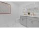 Bathroom offers dual sinks with modern faucets, sleek toilet, and decorative wall art at 1113 Black Acre Trl, Winter Springs, FL 32708