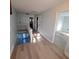 Upstairs hallway with hardwood floors and white staircase, connecting various rooms of the house at 1150 Lake Blanche Dr, Orlando, FL 32808