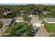 Aerial view of a well-maintained property with lush lawn, mature trees, and a brick-lined driveway at 1232 Corbett Ln, Orlando, FL 32806