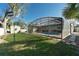 Beautiful backyard with lush lawn, convenient shed, and refreshing screened-in pool area at 1232 Corbett Ln, Orlando, FL 32806