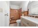 Bathroom with a walk-in shower, commode, and vanity with marble countertop at 1232 Corbett Ln, Orlando, FL 32806